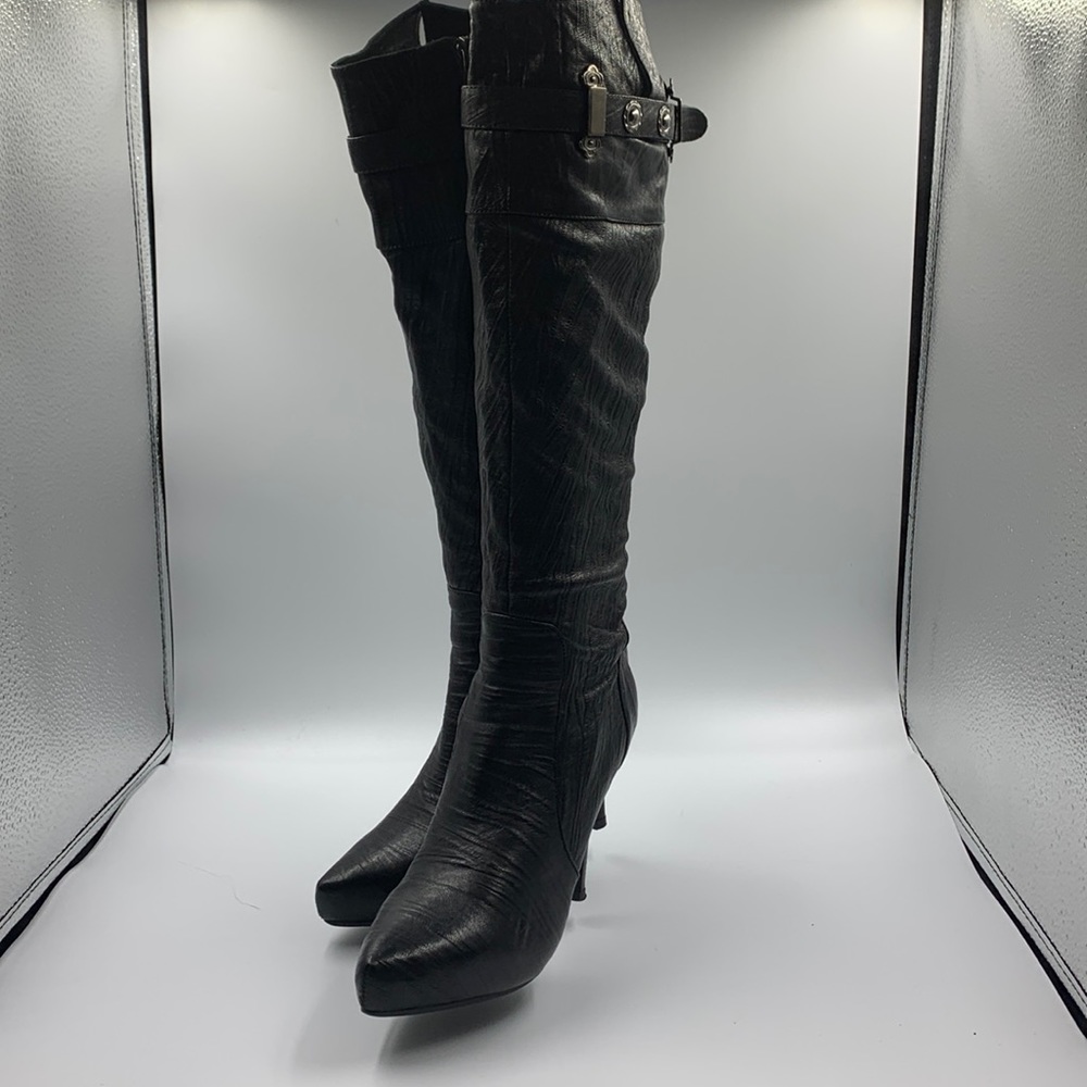 Black leather high heel boots.